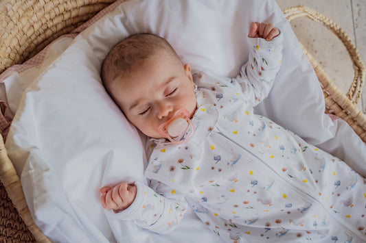 NB Baby sleeping in a pima cotton baby sleeping bag