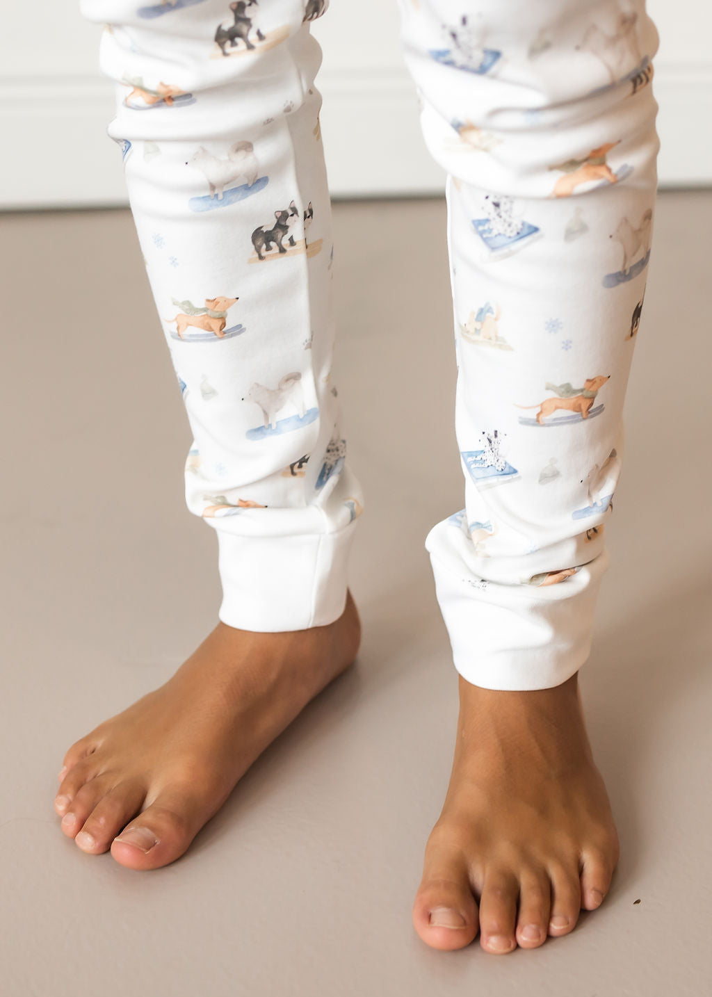 White pants with animal print worn by a person on a neutral background