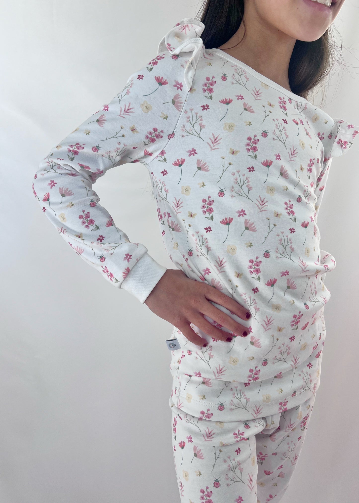 Person wearing a floral baby wrap against a plain background